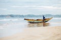 Weligama, Sri Lanka Ã¢â¬â December 21, 2017: Alone fisherman resting near his boat after the night fishing in the morning time in W